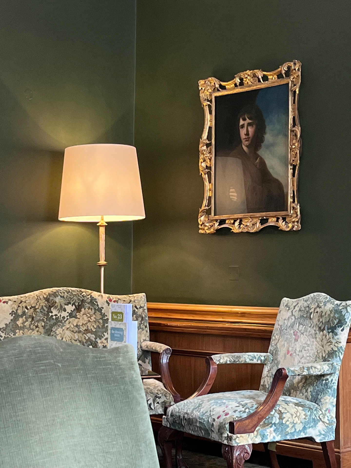The drawing room at The Merrion with art, lamps and upholstered chairs