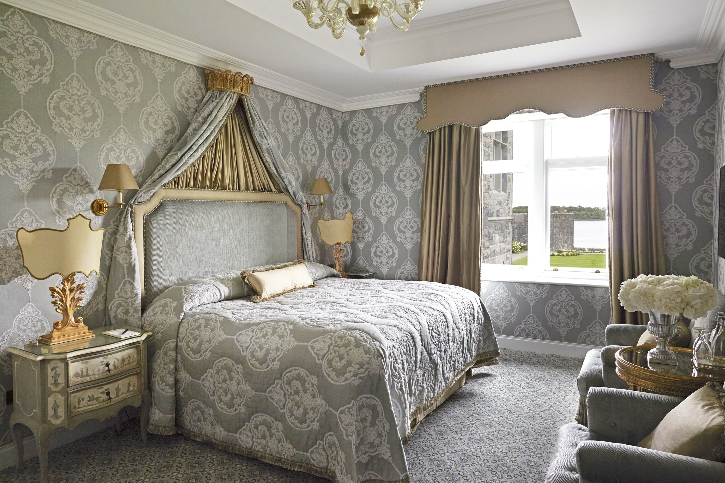 A Lake View Deluxe Room at Ashford Castle with a canopied bed and window to the lake