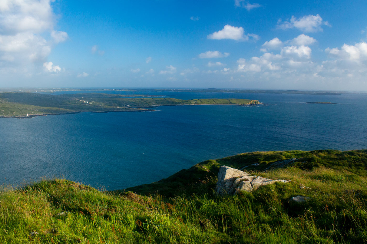 Connemara coastline from a high headland, Atlantic bays and offshore islands under broken cloud