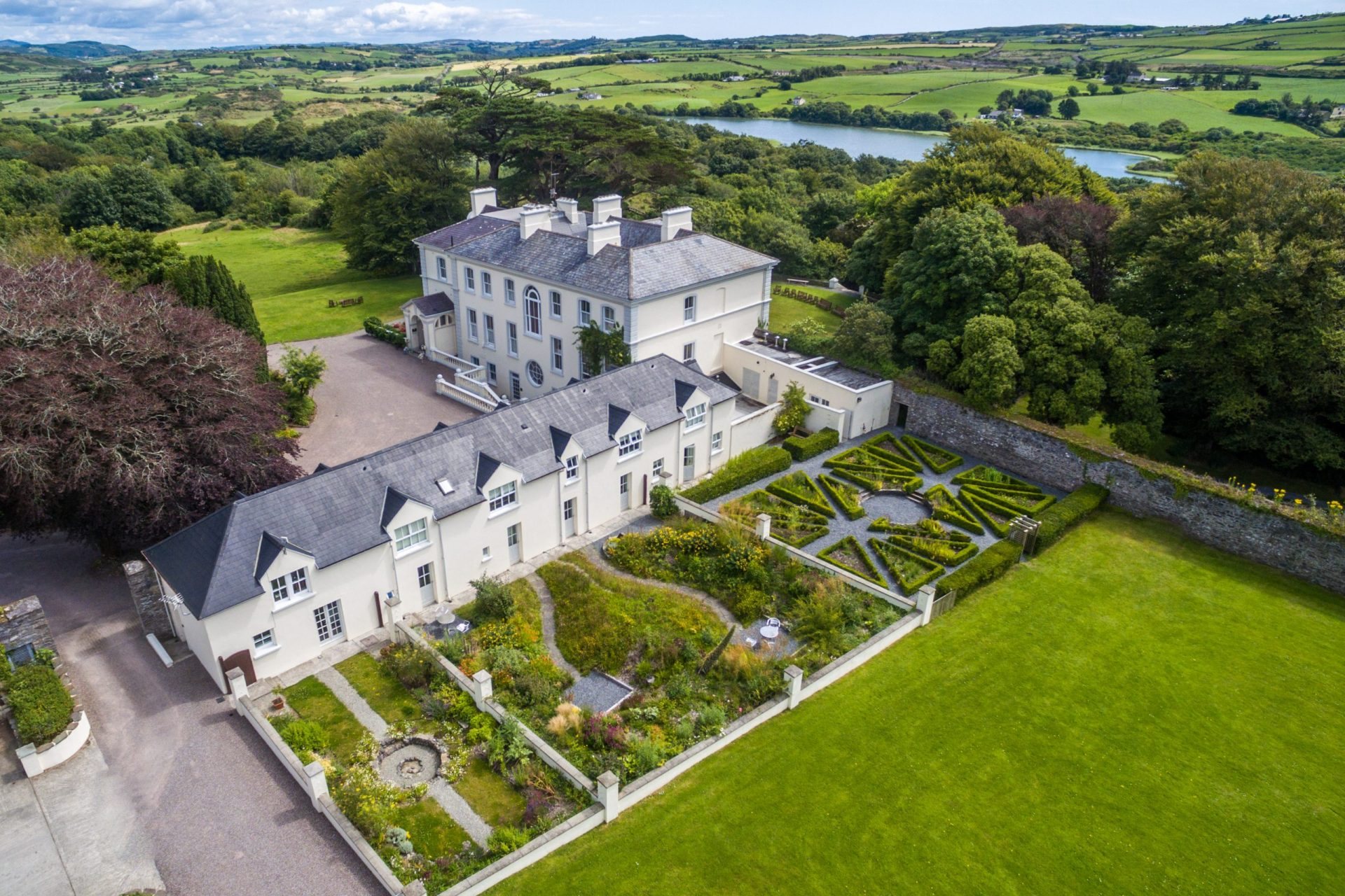 Liss Ard Estate's white Georgian manor and walled garden near Skibbereen, seen from the air