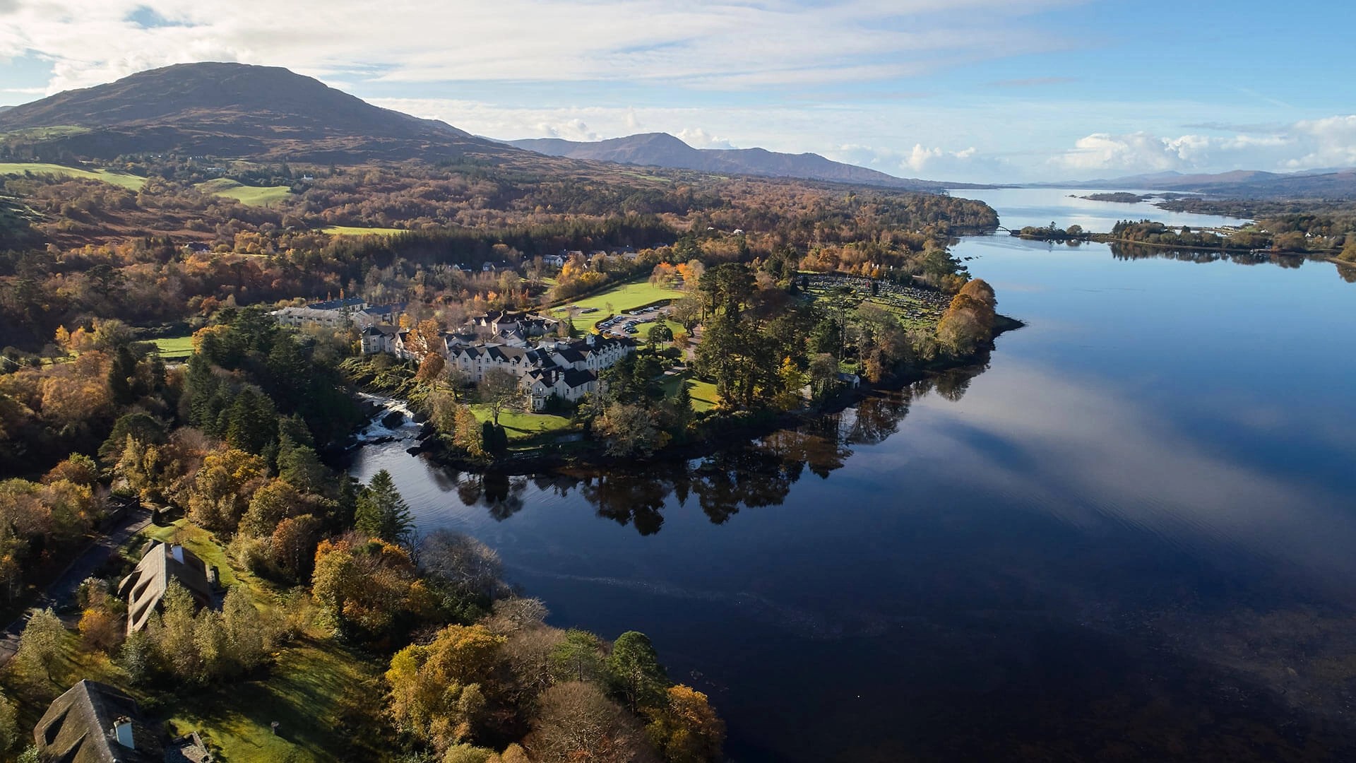 Sheen Falls Lodge and its wooded grounds on Kenmare Bay seen from the air