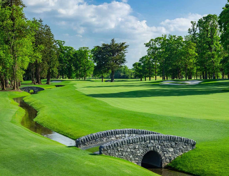 A stone bridge crossing water on the golf course at Adare Manor