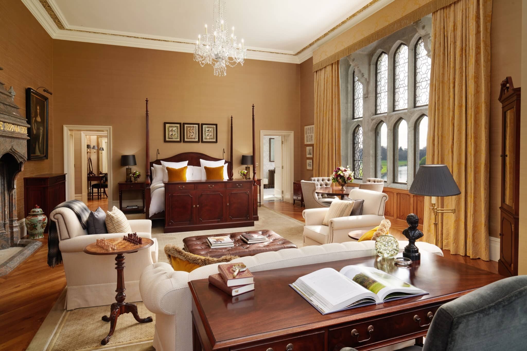 A Dunraven Stateroom at Adare Manor with Gothic windows, four-poster bed and sitting area