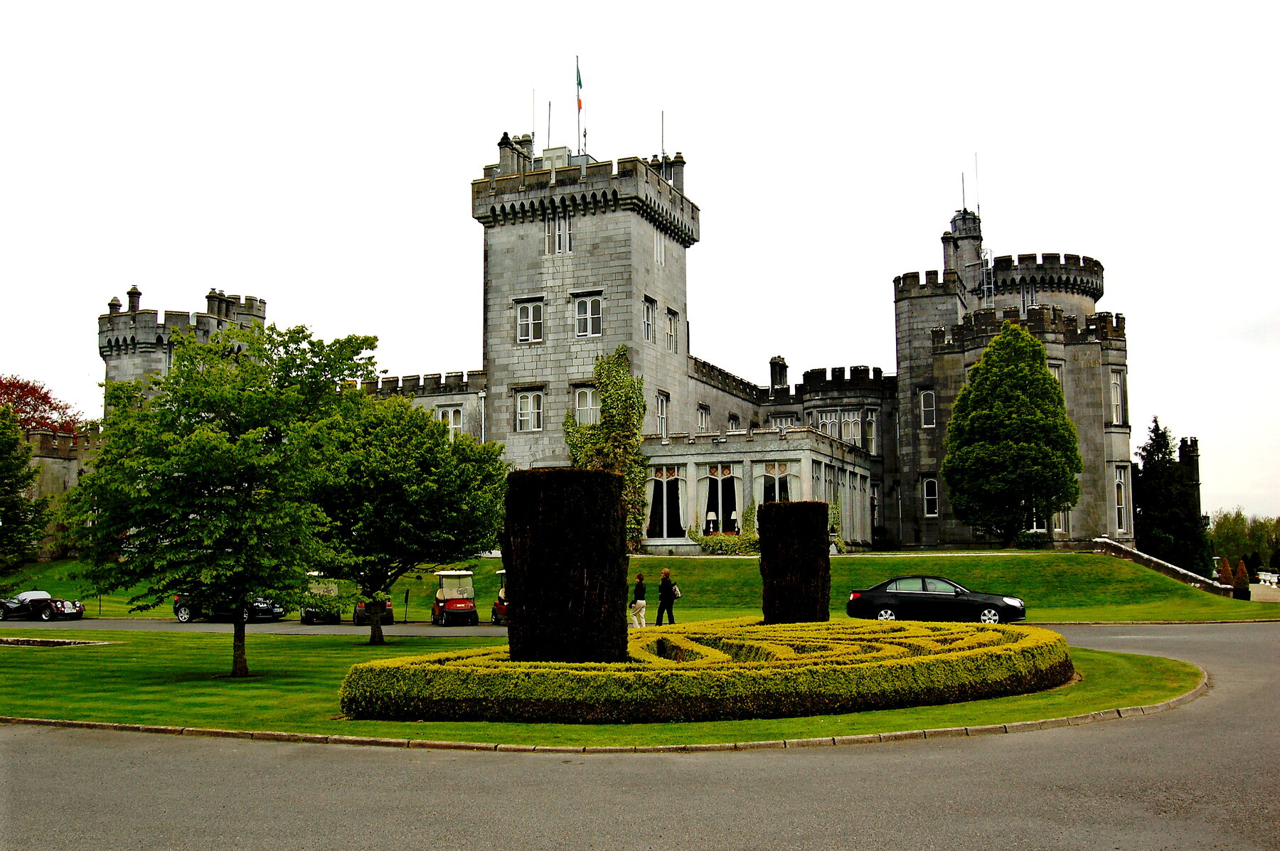 Dromoland Castle towers above its parkland at golden hour
