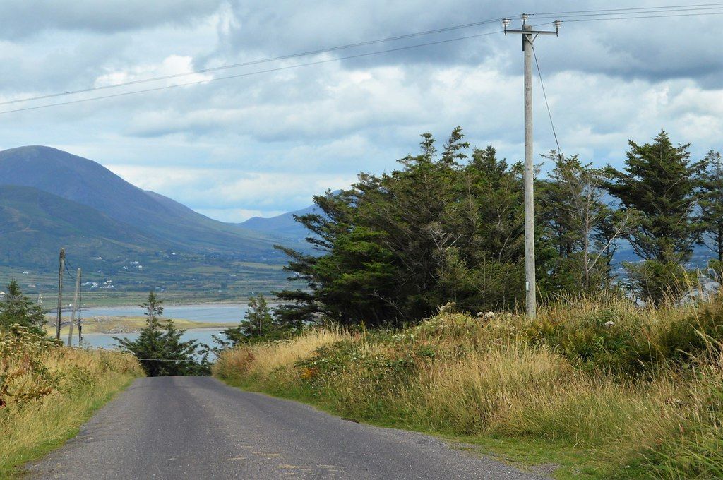 A quiet Irish coastal road in evening light