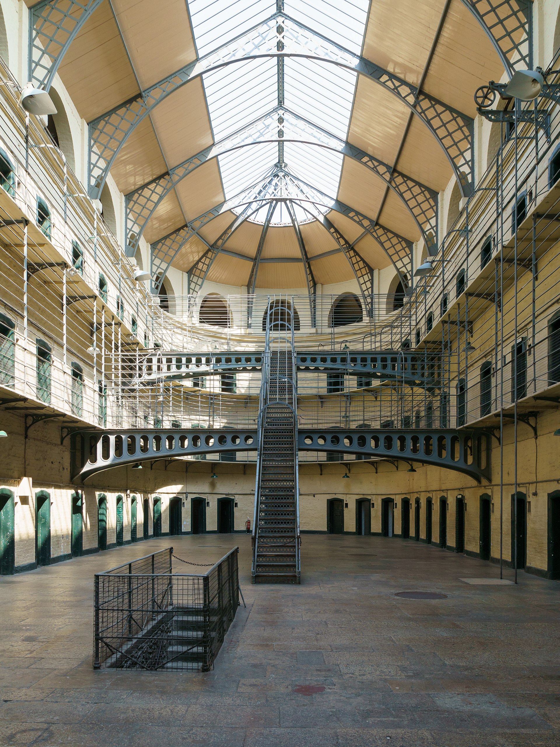 The East Wing of Kilmainham Gaol, Dublin, its cast-iron tiers rising under a domed skylight.